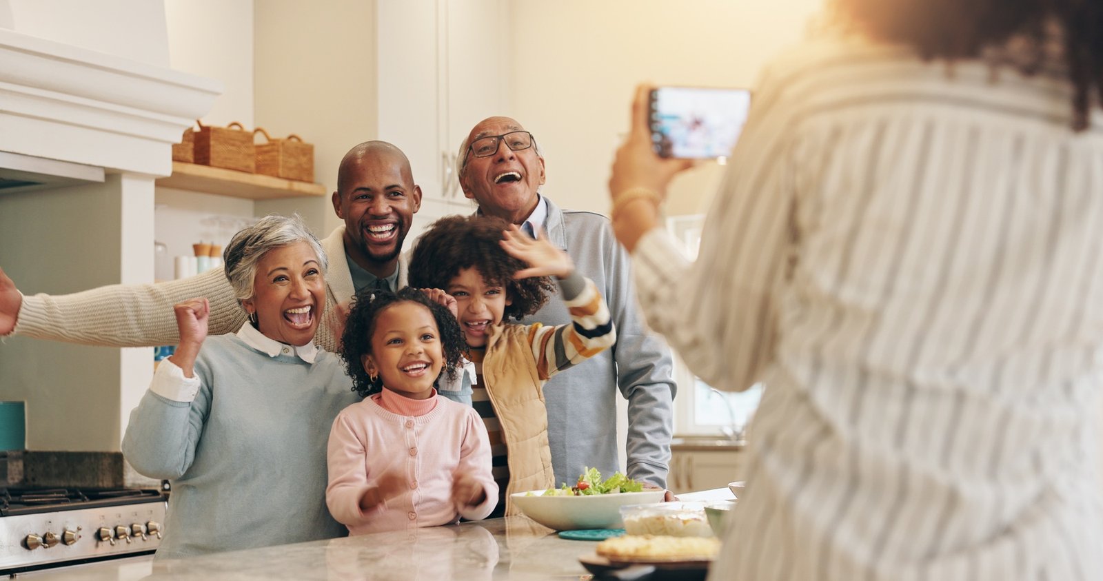 Happy, family and picture in home kitchen for bonding together, reunion memory and fun relationship